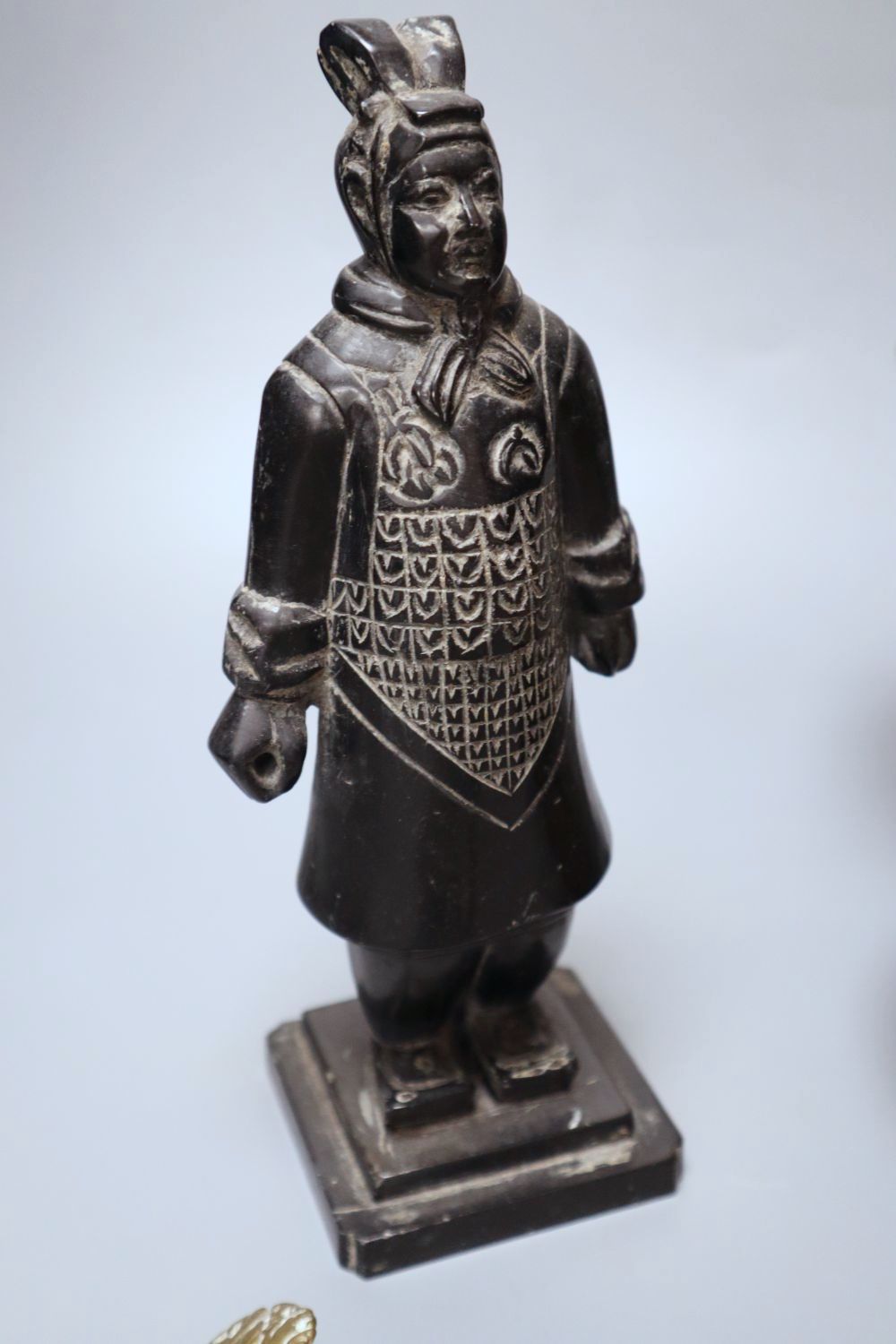 A Himalayan Buddhist brass lamp/ewer with related ladle, 26cm, 19th/20th century and a carved black mineral Chinese stone figure